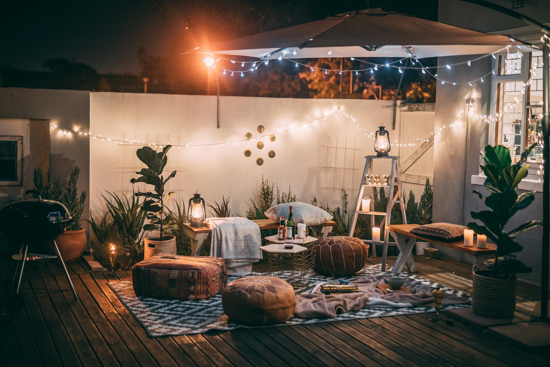 Outdoor String Lights Evening Ambiance Cozy outdoor patio at night with warm string lights and comfortable seating