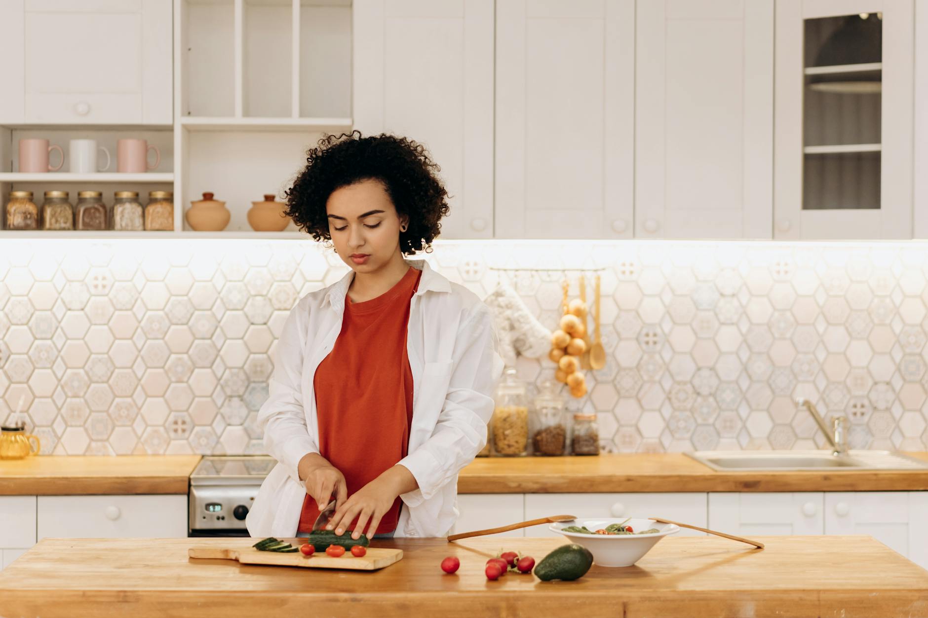 Preparing Fresh Vegetables for Healthy Cooking Methods Woman slicing fresh vegetables in a modern kitchen — preparing ingredients for healthy cooking