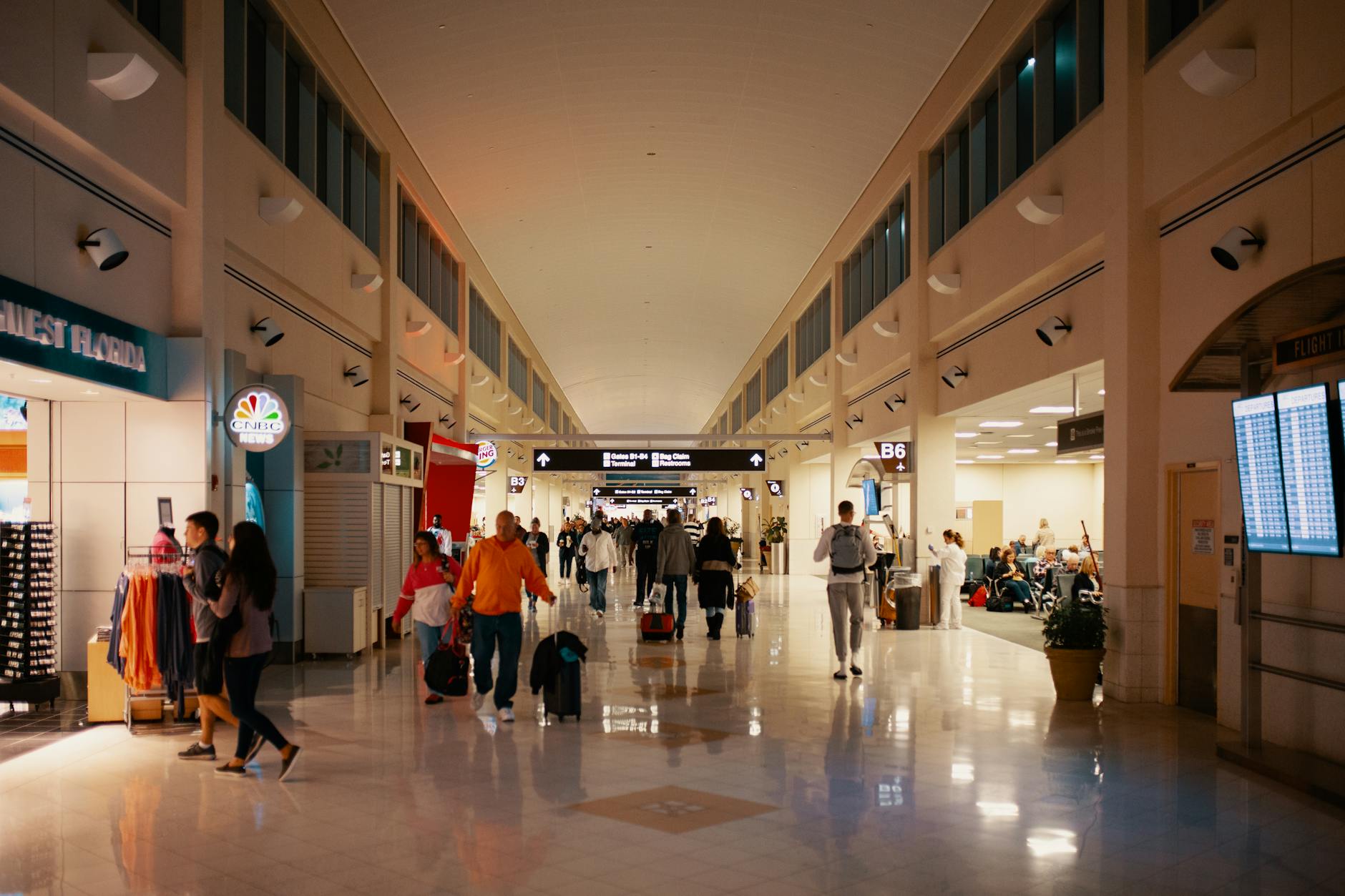 Airport Terminal Crowds and Travel Busy airport terminal hallway with travelers passing through