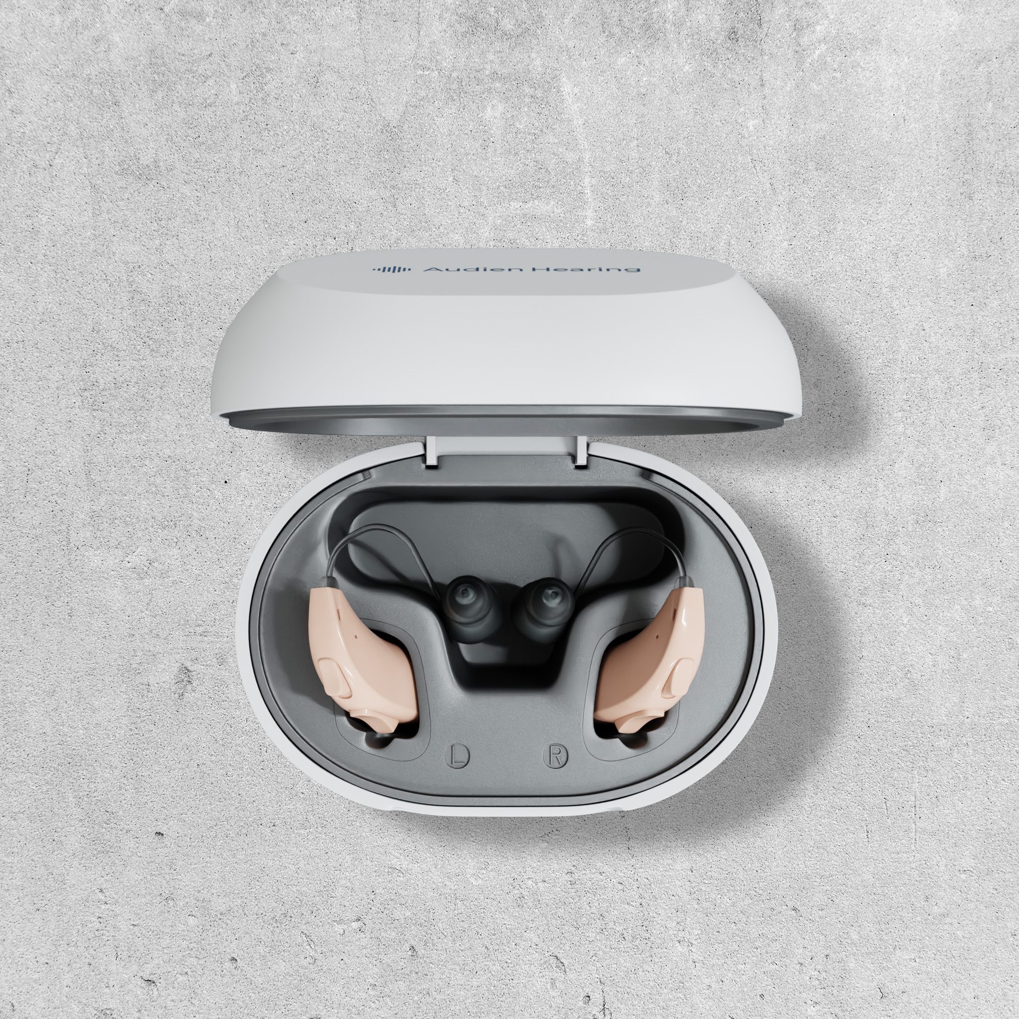 Audien Atom One Hearing Aids in Charging Case 2026 Audien Atom One hearing aids in charging case on dark fabric surface with blue ambient lighting