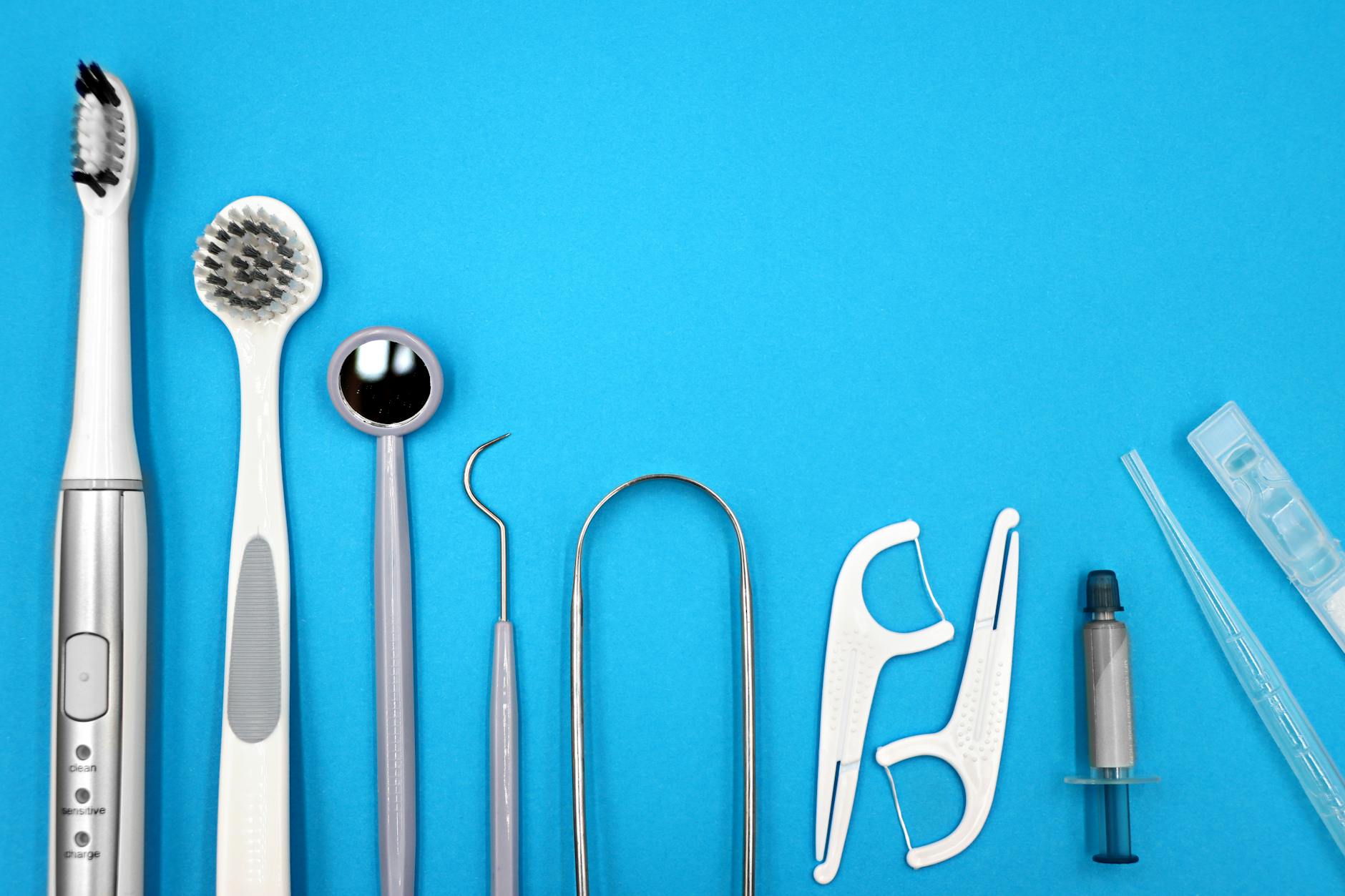 Complete Dental Hygiene Tools for Fresh Breath Flat lay of dental care tools including toothbrushes and floss for a complete oral hygiene routine
