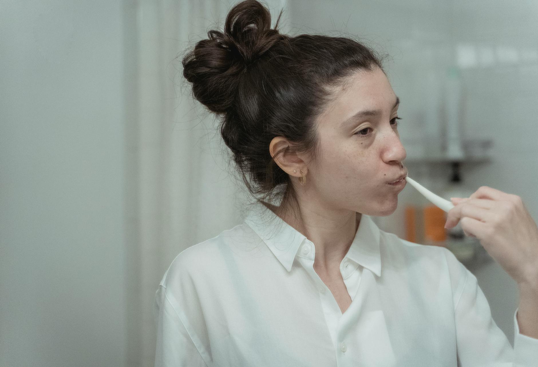 Brushing Teeth Oral Hygiene Routine Woman brushing her teeth as part of a daily oral hygiene routine