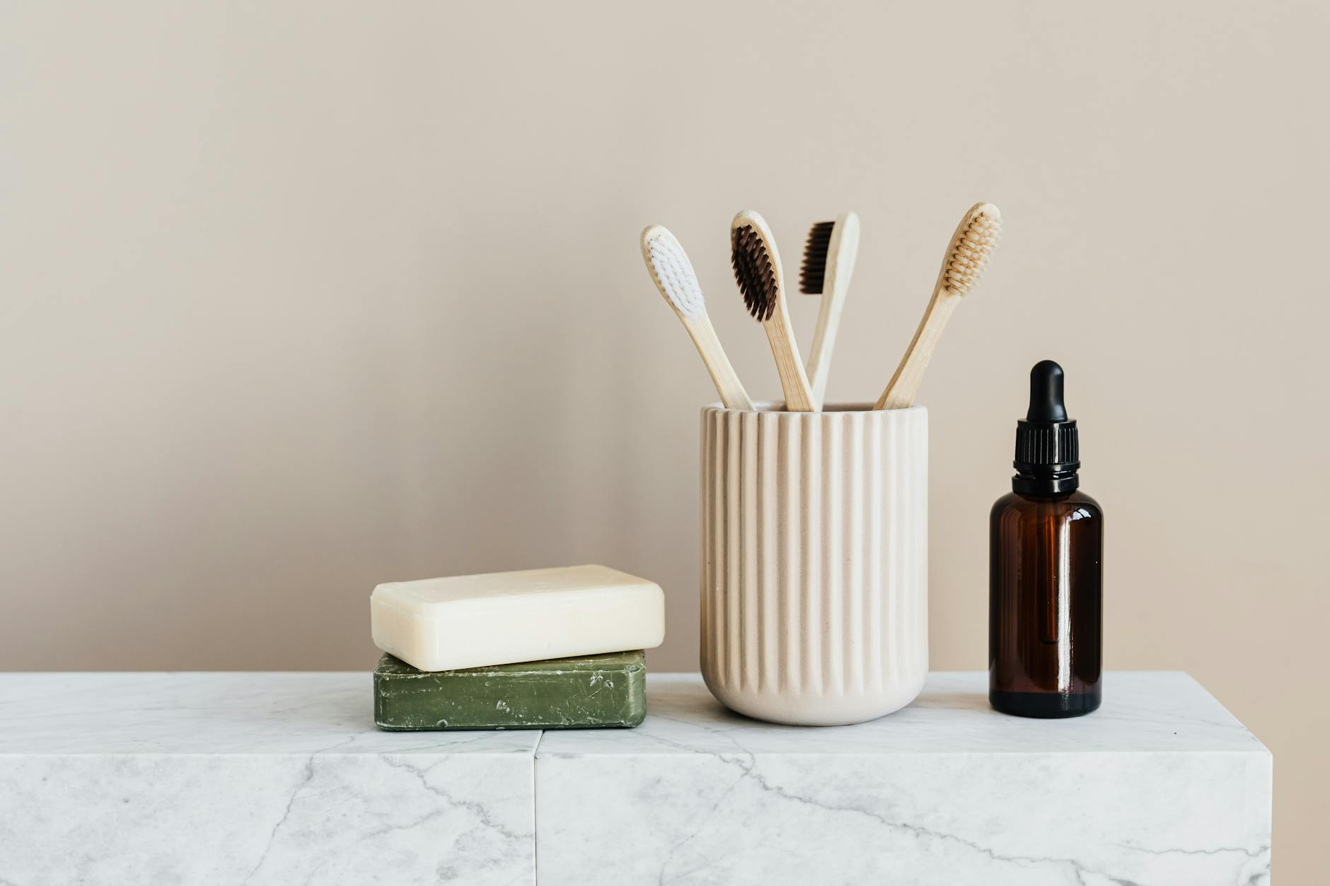 Bathroom Cleaning Supplies Organization Organized eco-friendly bathroom supplies including soaps and toothbrushes on a marble surface