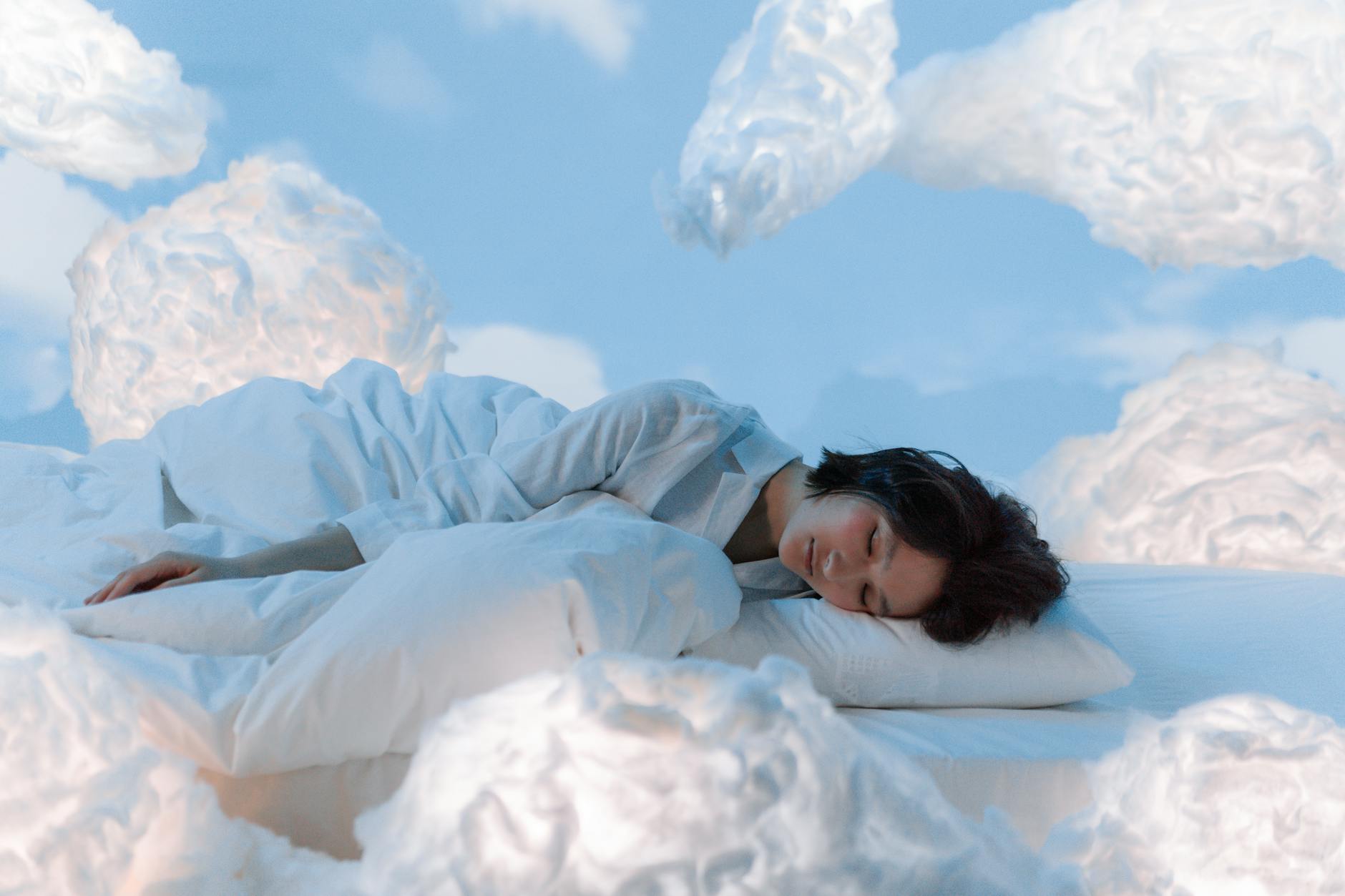 Peaceful Sleep Through Breathing Exercises Woman in a peaceful, dreamy sleep surrounded by soft clouds — representing the goal of restful sleep through breathing exercises