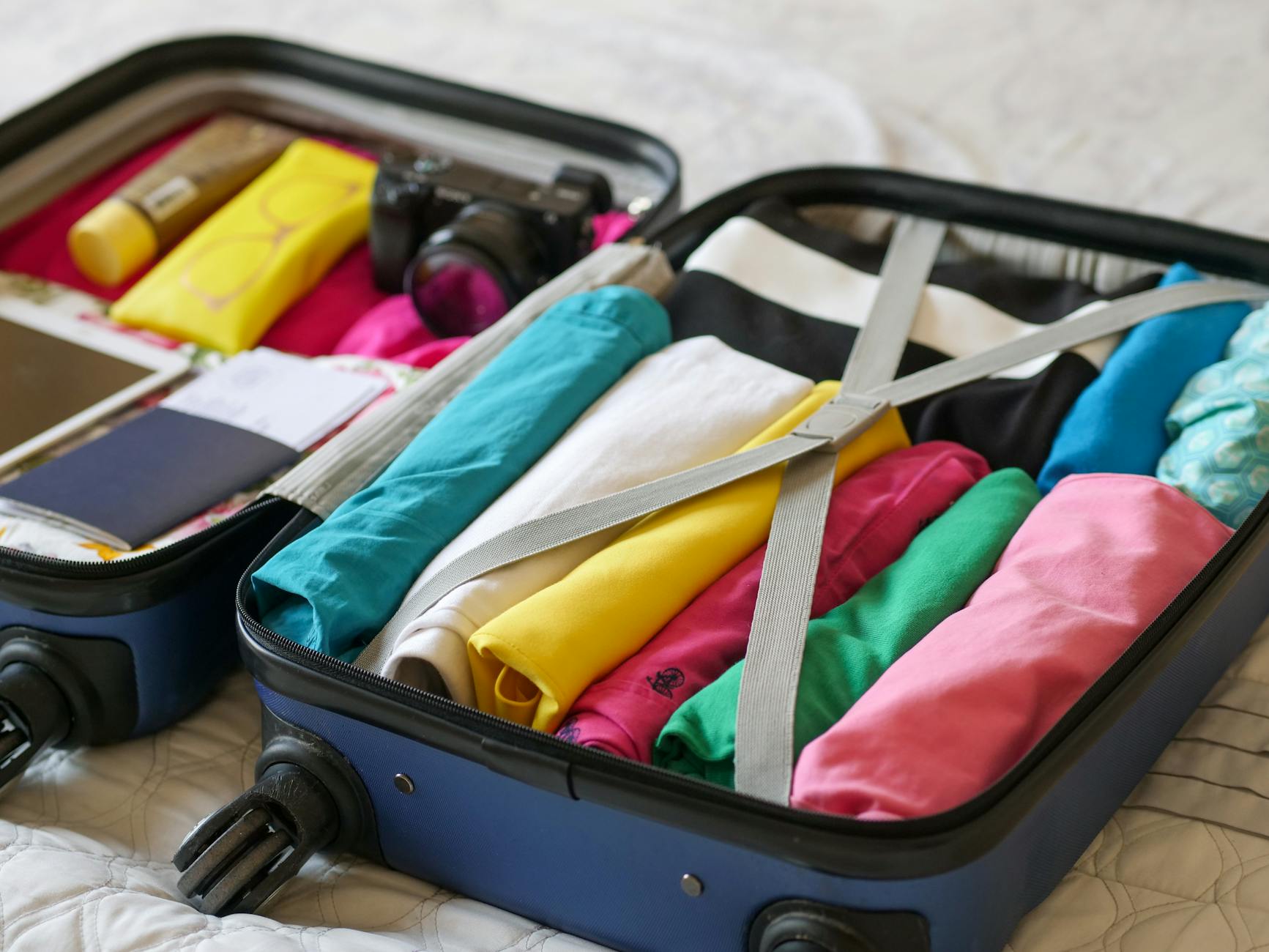 Organized Carry-On Packing for Efficient Travel Open suitcase neatly packed with clothes and travel essentials for carry-on only travel