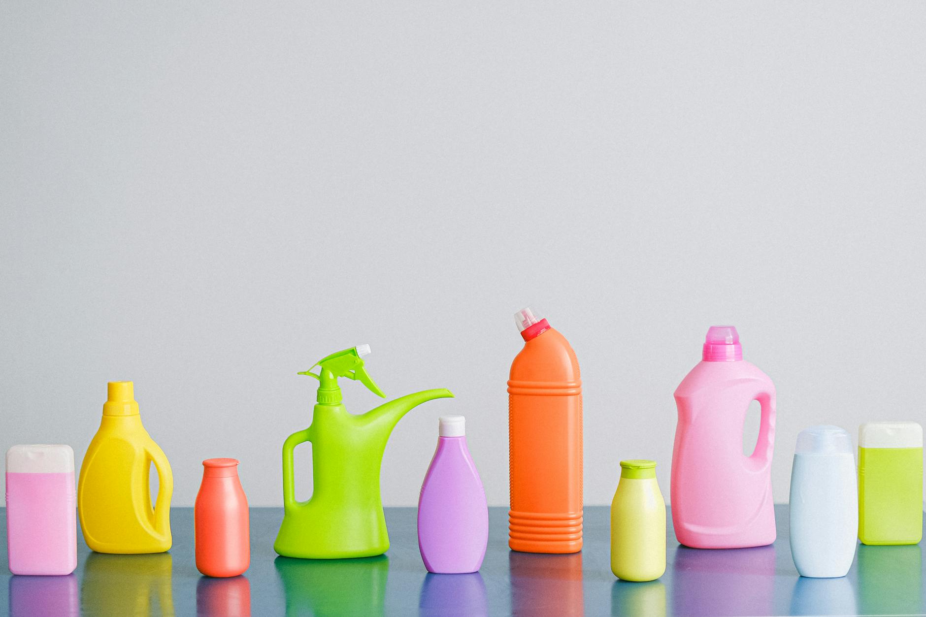 Common Cleaning Supplies — More Isn't Always Better An assortment of cleaning product bottles and spray containers arranged together