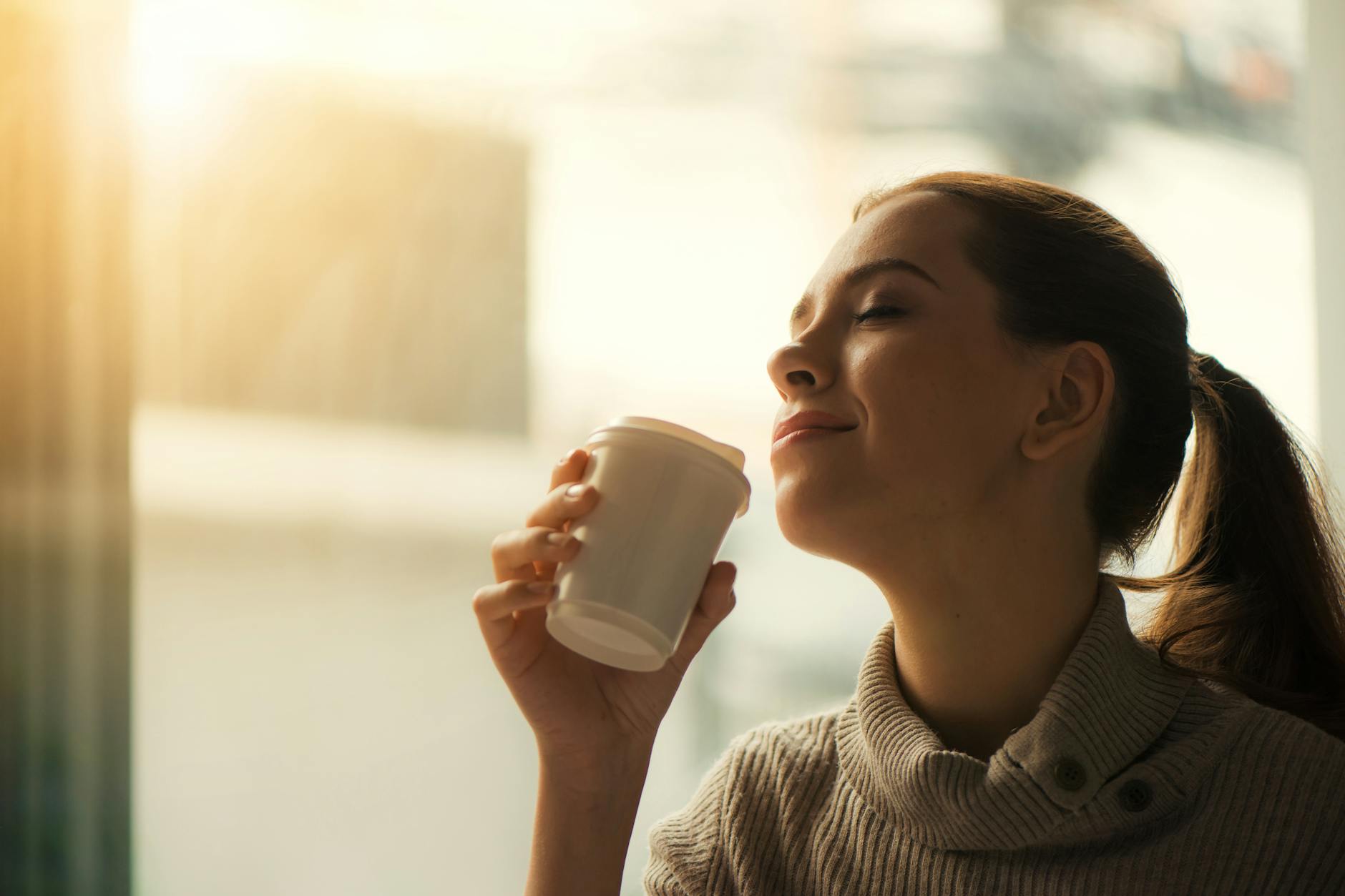 Morning Coffee and Teeth Staining Prevention Woman enjoying her morning coffee by the window — understanding coffee staining habits