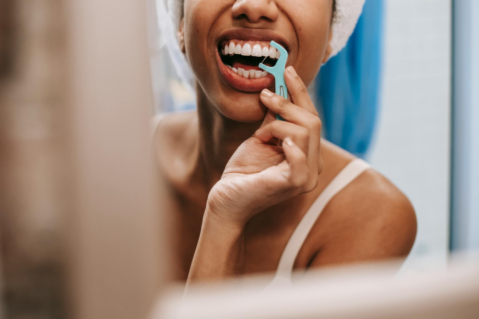Oral Hygiene Routine for Coffee Drinkers Woman practicing oral hygiene — flossing as part of a consistent teeth care routine