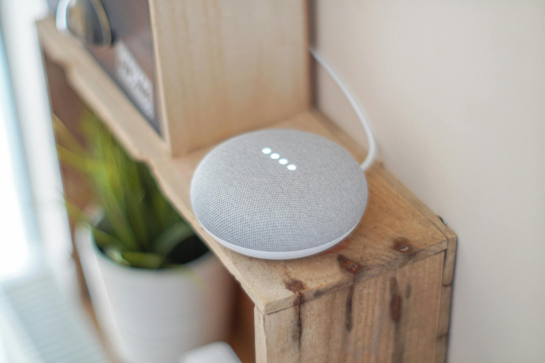 Smart Home Gadgets for Christmas 2026 A smart home speaker sitting on a wooden shelf, representing modern connected home devices