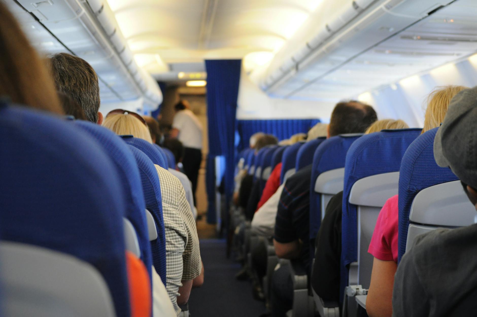Economy Class Syndrome - Prolonged Sitting Risk on Long-Haul Flights Passengers seated in an airplane cabin during a long-haul flight, illustrating DVT risk from prolonged sitting