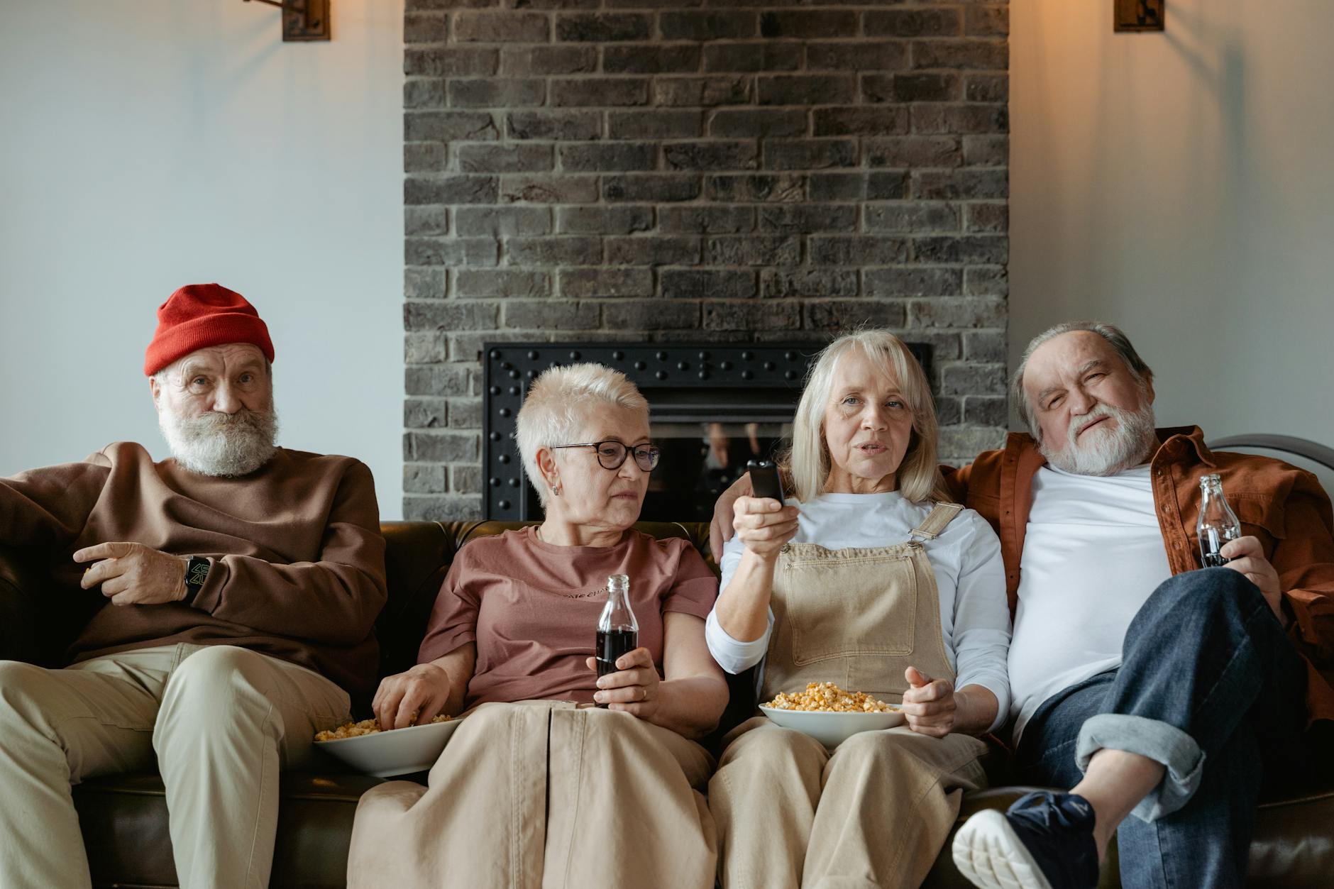 Turning Up the TV Volume — A Common Early Sign of Hearing Loss Elderly friends watching television together indoors