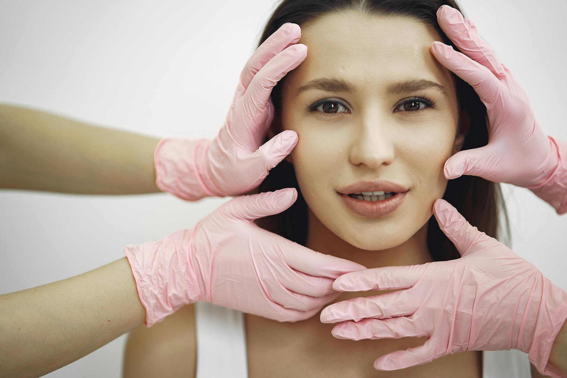 Professional Facial Treatment Session 2026 Woman receiving a professional facial treatment in a clinical setting with gloved hands