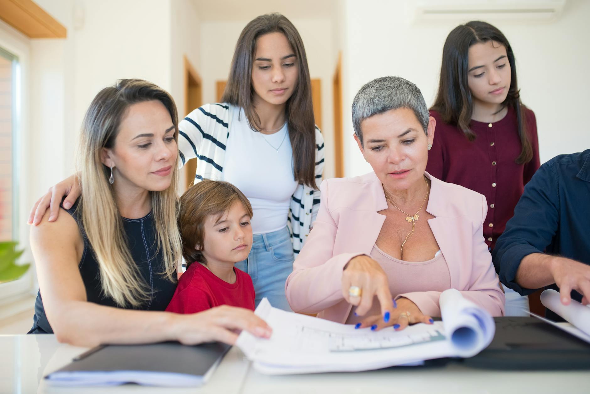 Family Legacy Planning Discussion 2026 Family reviewing estate planning documents together with advisor