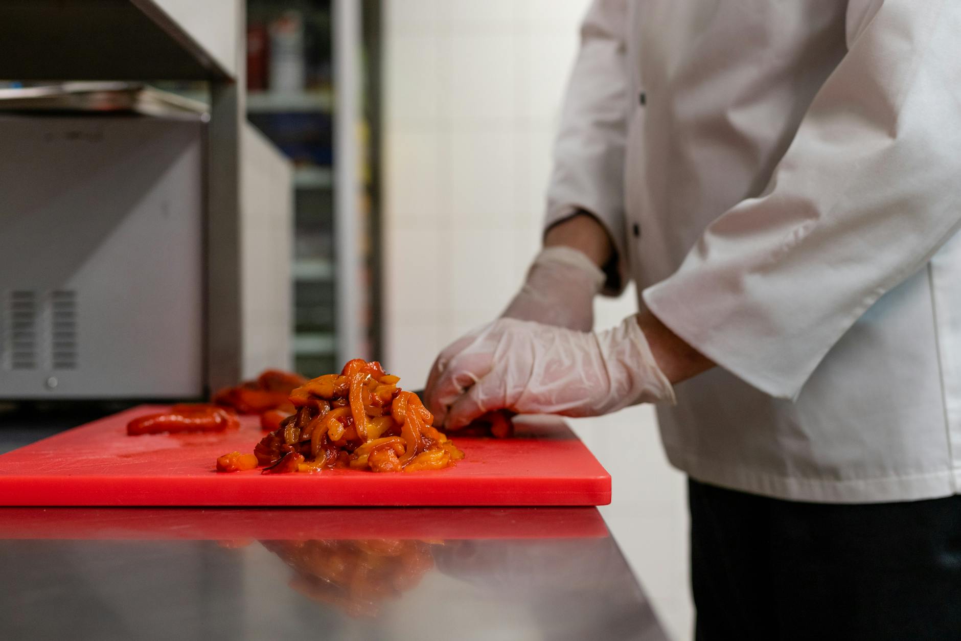 Color-Coded Cutting Board for Kitchen Food Safety 2026 Chef chopping vegetables on a red color-coded cutting board in a kitchen — color-coded boards prevent cutting board cross contamination