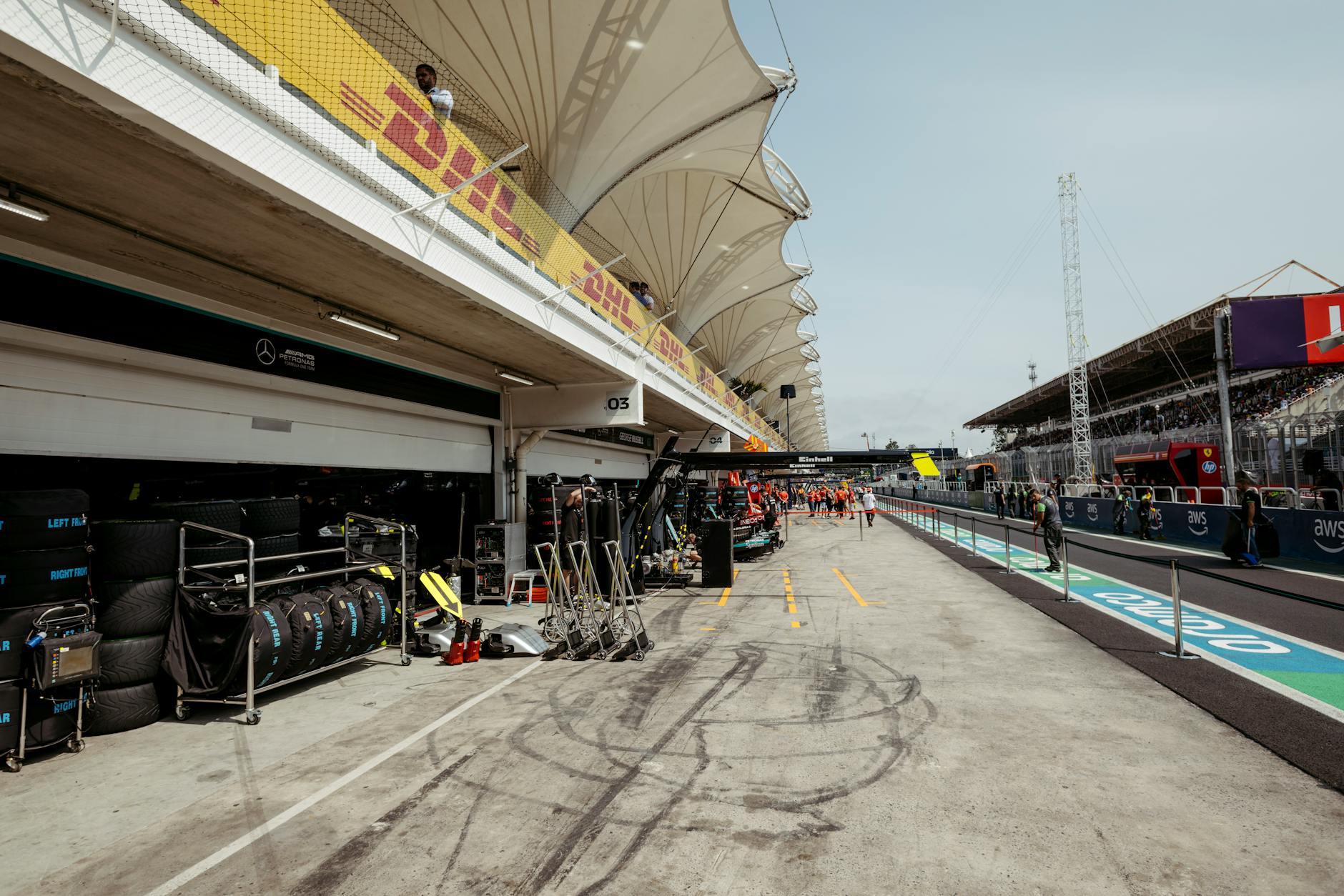 F1 Pit Lane View During Race Weekend Formula 1 pit lane with garages visible and race equipment during a grand prix weekend