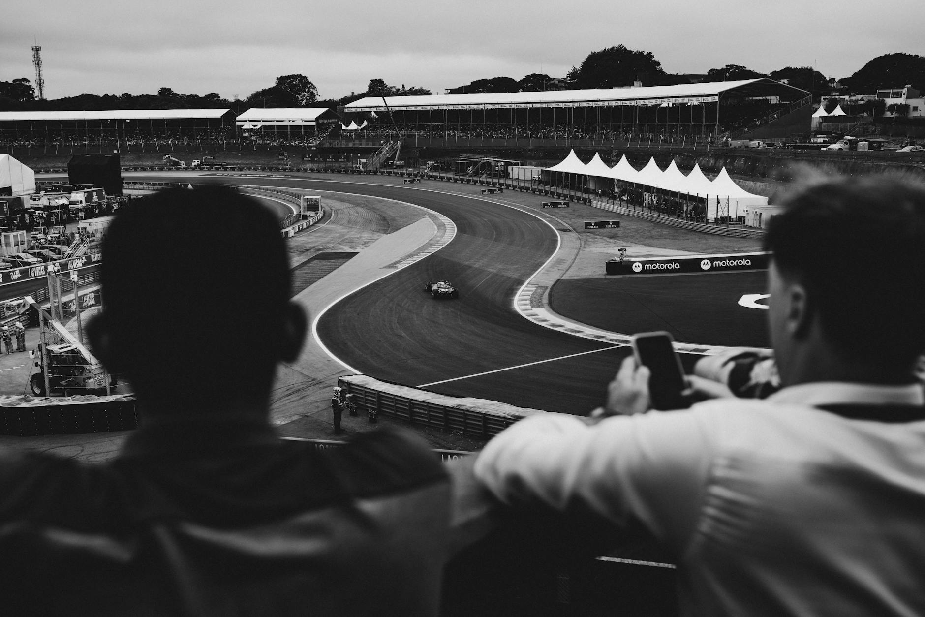 Motorsport Spectators at Grandstand Race Weekend Motorsport spectators watching racing from the stands in black and white