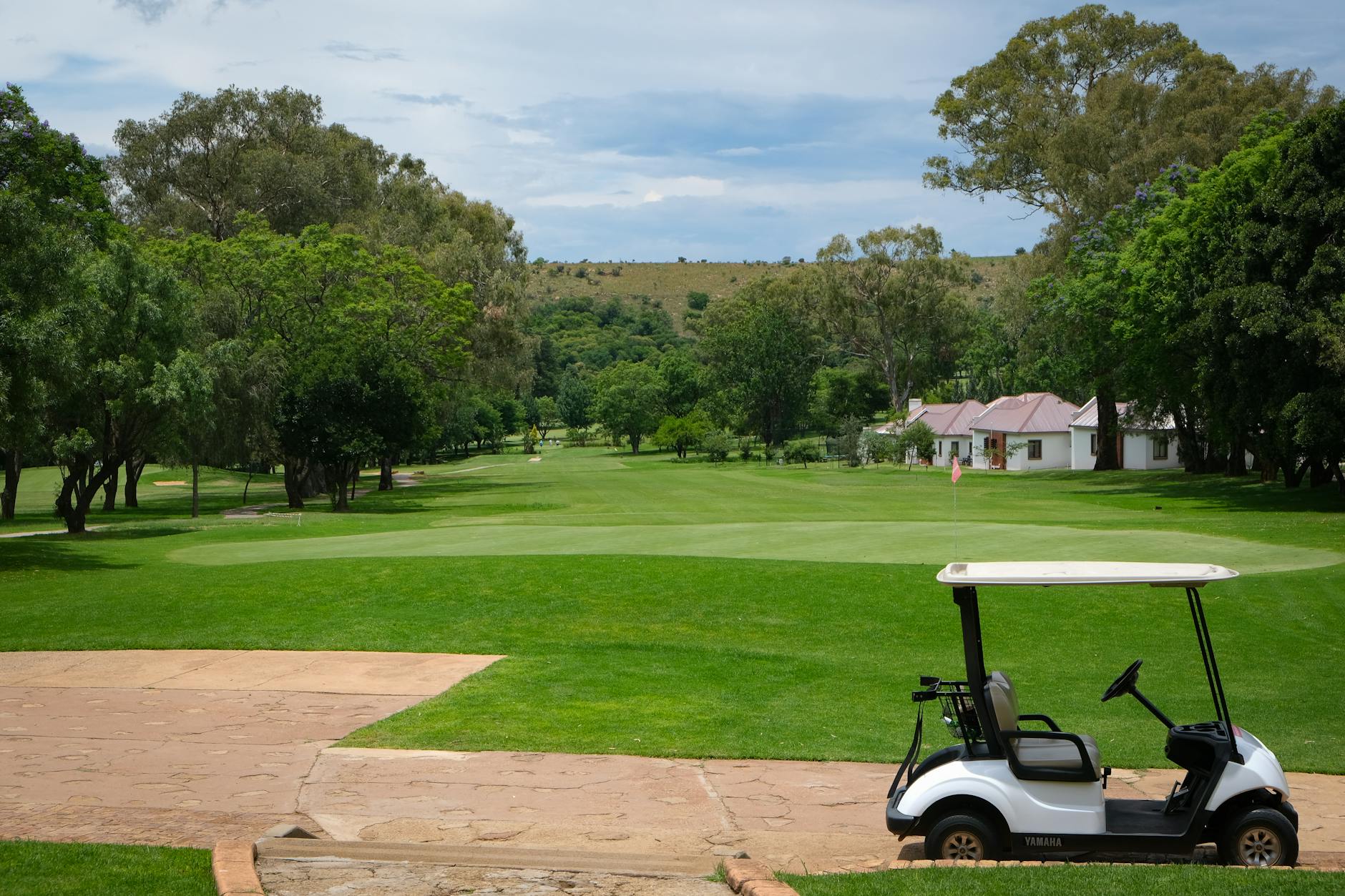 Golf Cart Fairway Etiquette and Pace of Play A golf cart parked on a sunny fairway — understanding cart paths and pace of play is essential for first time golfing tips