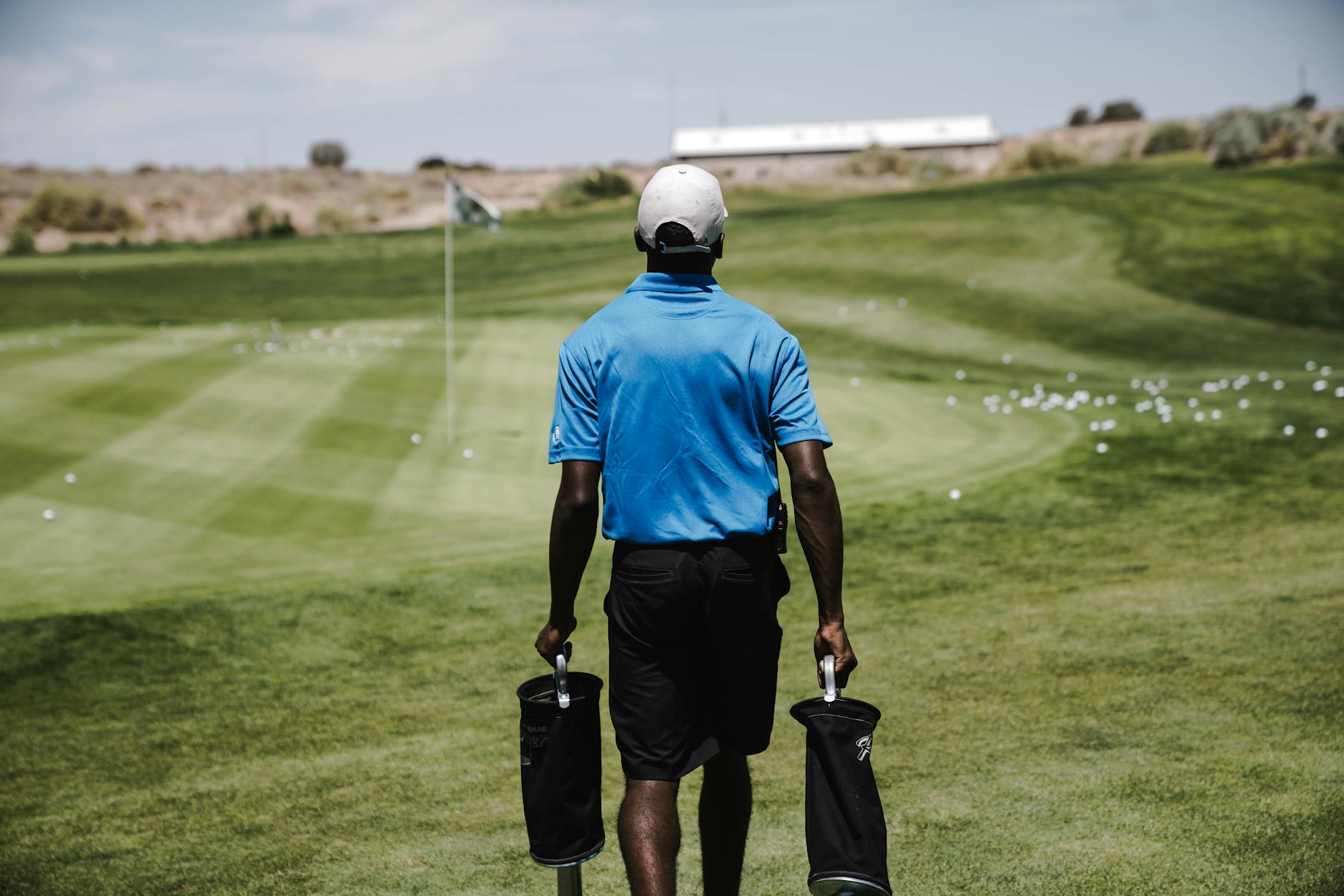 Golf and Stress Relief - Nature Walk on the Course Golfer walking on a sun-drenched course fairway surrounded by lush green trees