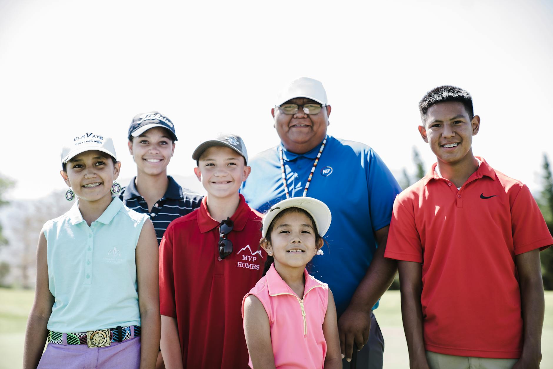 Golf Social Connection and Mental Health Benefits A group of friends enjoying a sunny round of golf together, sharing a laugh on the fairway