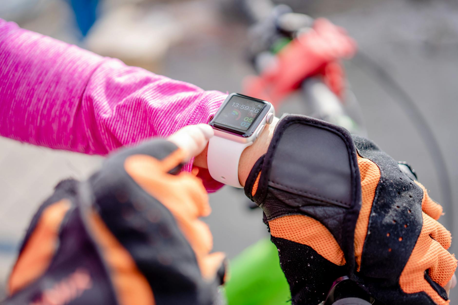 Fitness Tracker Smartwatch for Athletes 2026 Cyclist checking a smartwatch during exercise outdoors