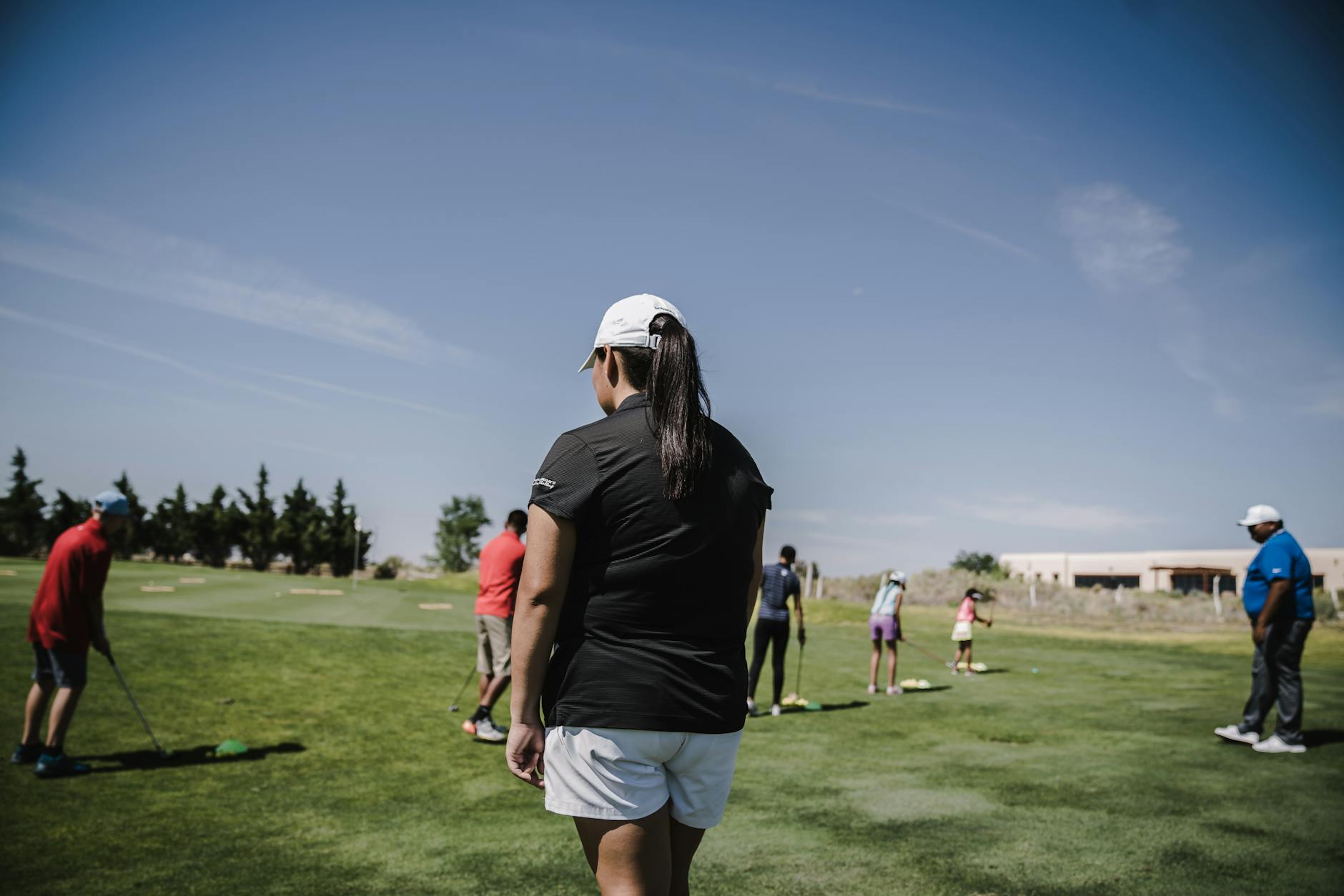 Golfers Learning the Game Together Group of golfers receiving instruction on a sunny golf course