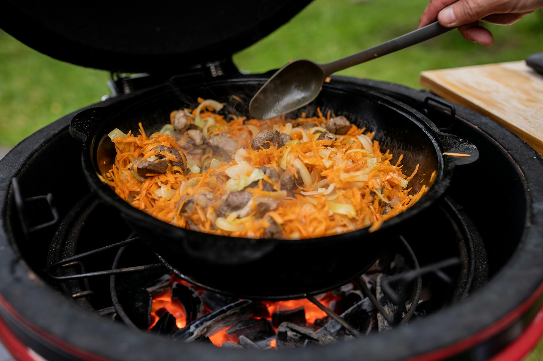 Cast Iron Skillet Over Open Flame - High Grease Fire Risk Cast iron skillet with food cooking over open flame — a scenario where grease fire risk is high