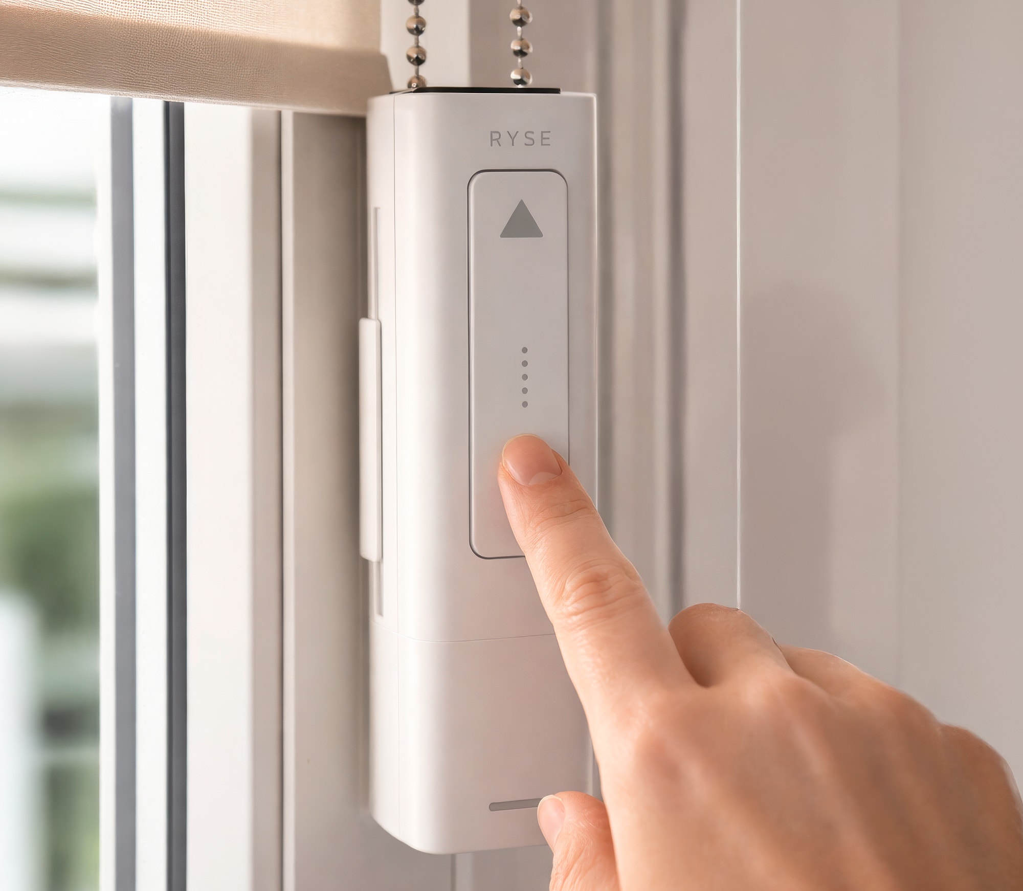 RYSE SmartShade Lifestyle Room Setting 2026 RYSE SmartShade installed in a modern living room setting showing automated shade control