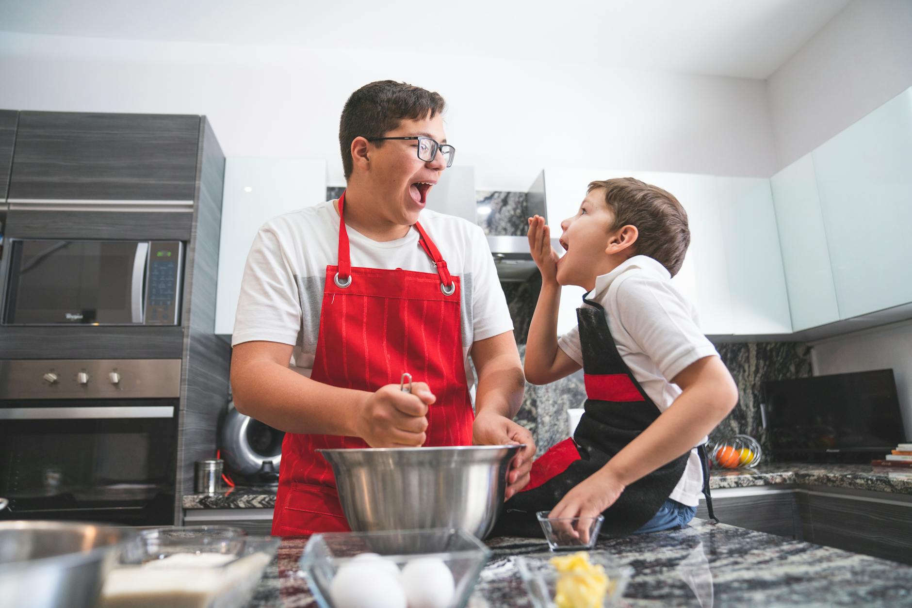 Kitchen Fire Safety - Family Cooking Together 2026 Father and son cooking together safely in a modern kitchen