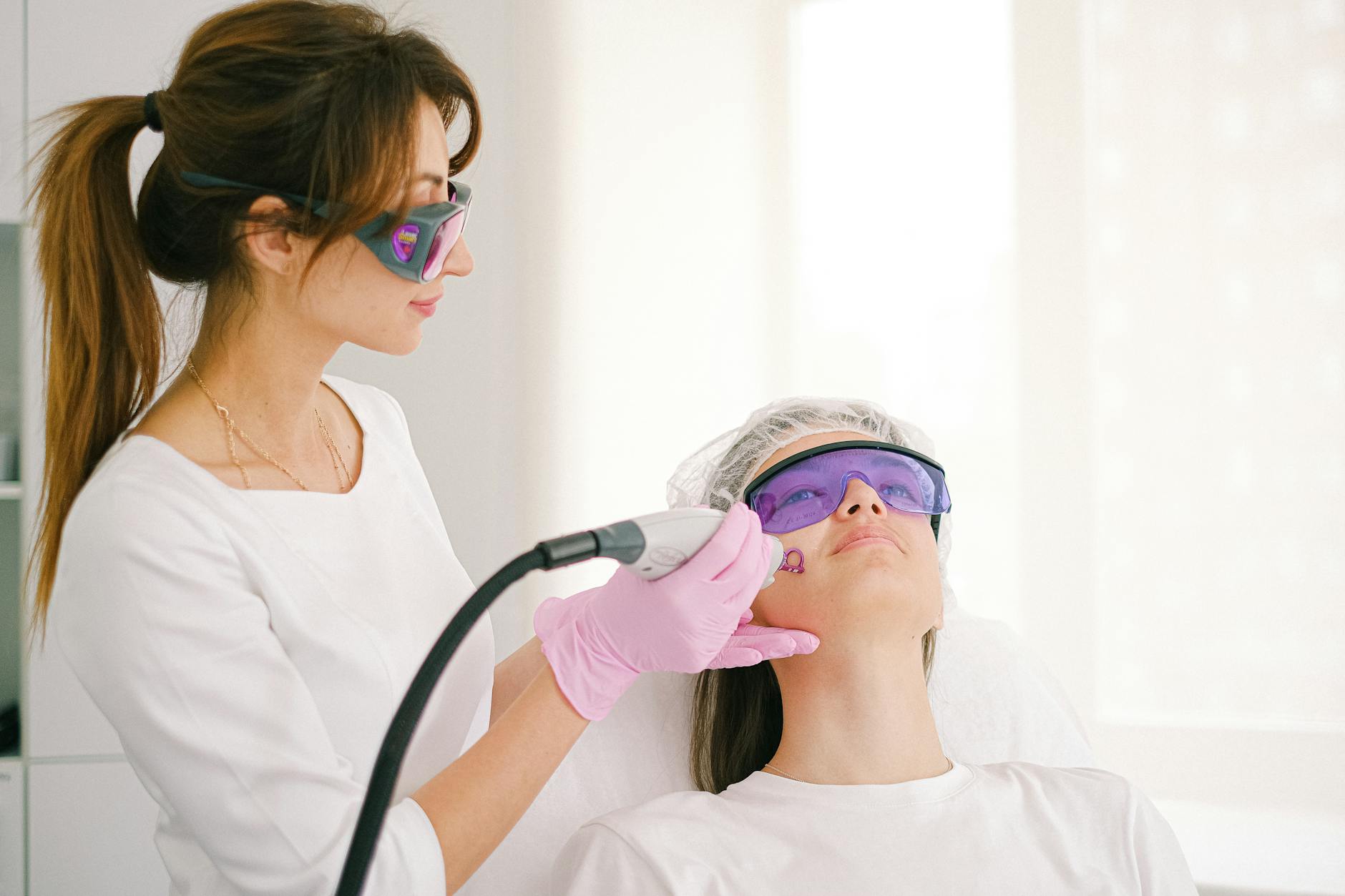 Professional Laser Facial Hair Removal Treatment 2026 Cosmetologist performing laser facial hair removal treatment on a woman in a professional clinic
