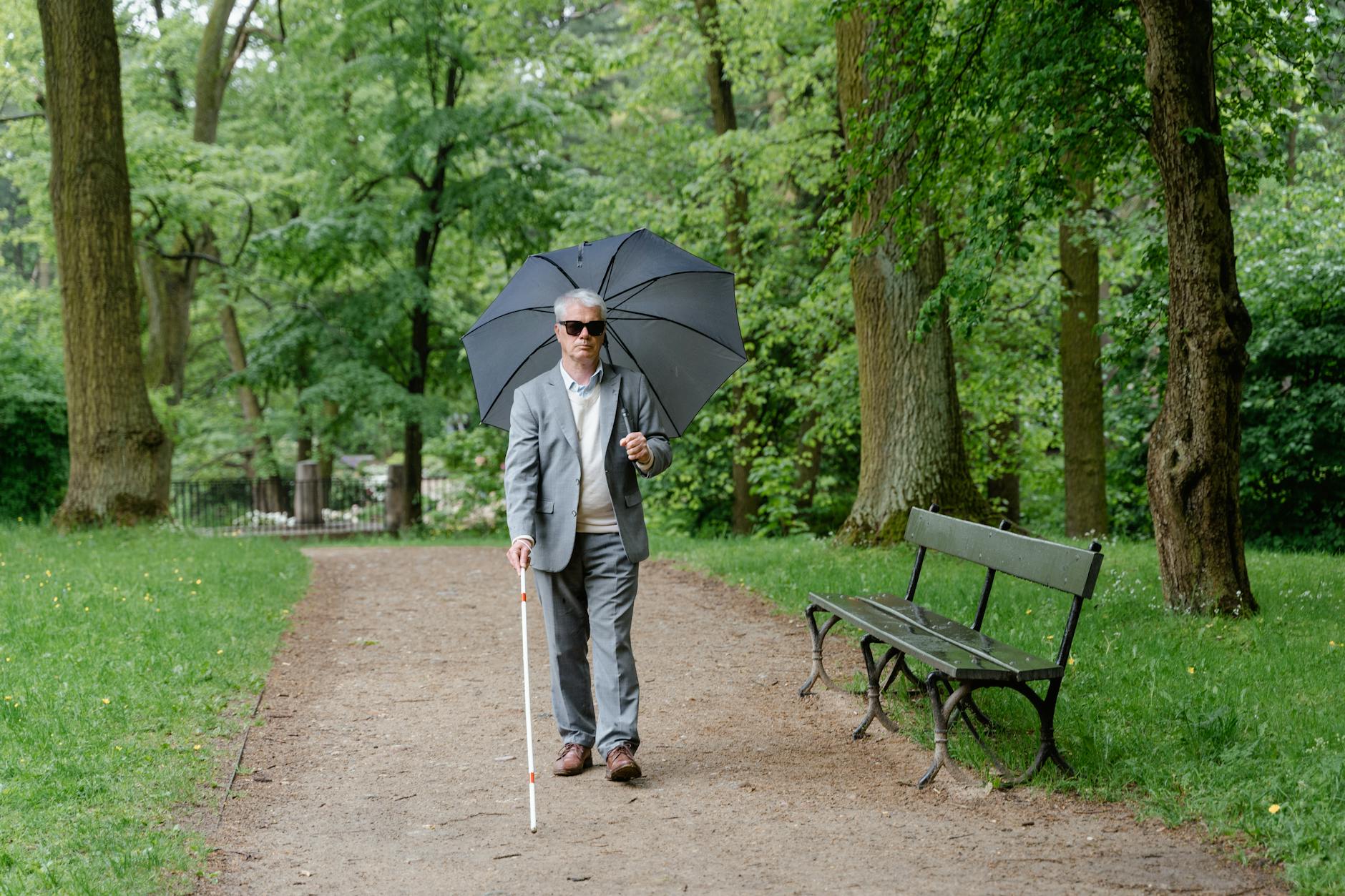 Staying active outdoors supports healthy leg circulation in seniors Senior man walking outdoors with a walking stick to stay active and improve leg circulation