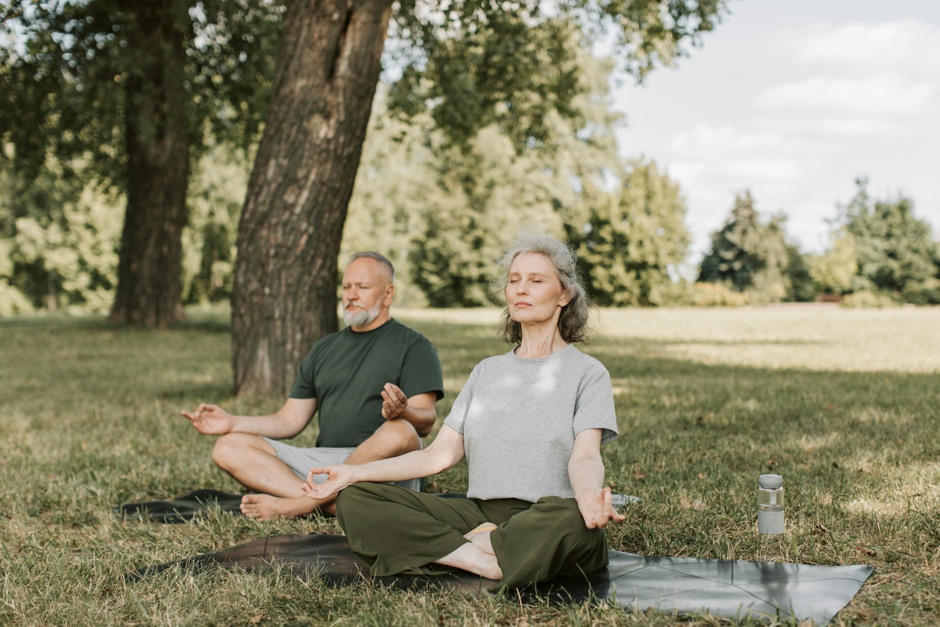 Long-Term Health Recovery After Smoking Cessation Senior couple meditating outdoors, representing long-term health recovery benefits after quitting smoking