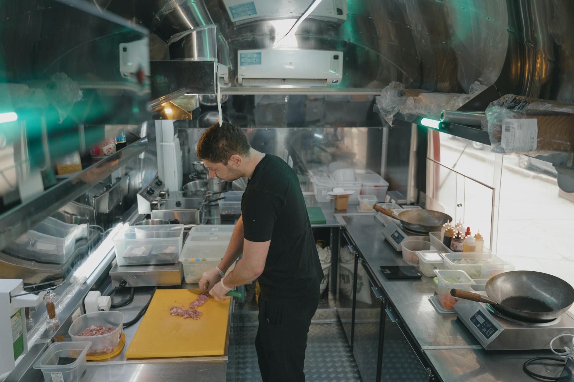 Plastic Cutting Board Food Safety 2026 Chef slicing ingredients on a yellow plastic cutting board in a professional kitchen