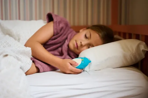 Moonbuddy Tactile Breathing Device in Use 2026 Child holding Moonbuddy breathing device during a calming session