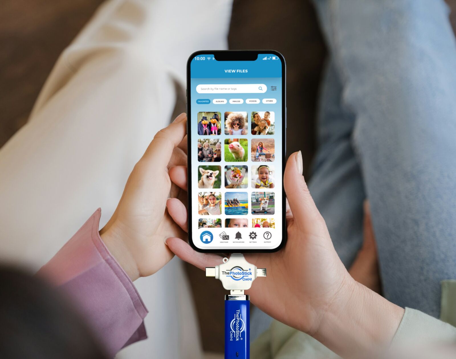 ThePhotoStick Omni Smartphone Backup 2026 ThePhotoStick Omni connected to a smartphone showing backup in progress