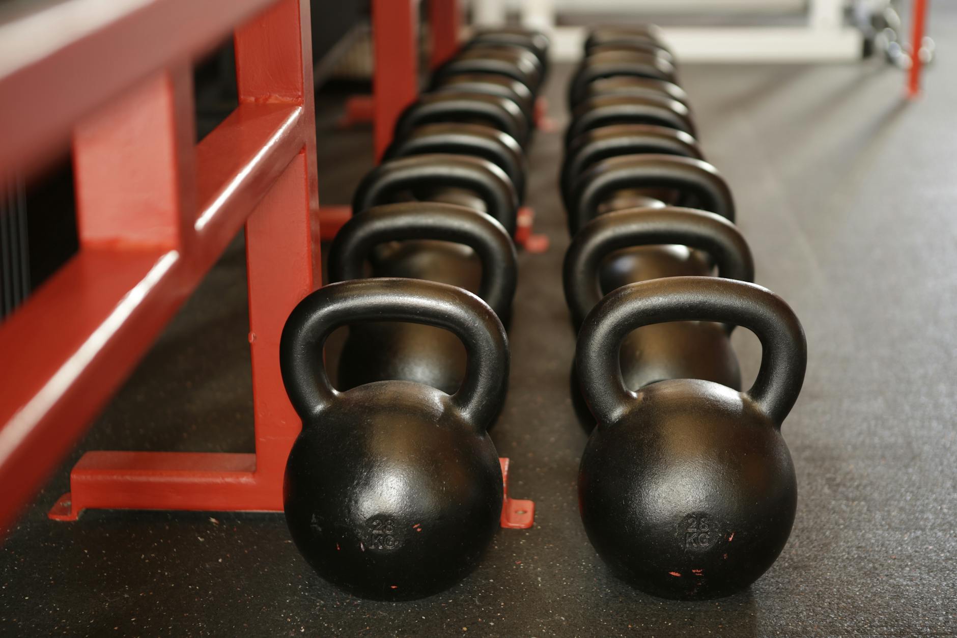 Free Weights Available at Budget Gyms 2026 Kettlebells and free weights lined up in a gym — Planet Fitness offers dumbbells up to 75 lbs but no barbells or squat racks