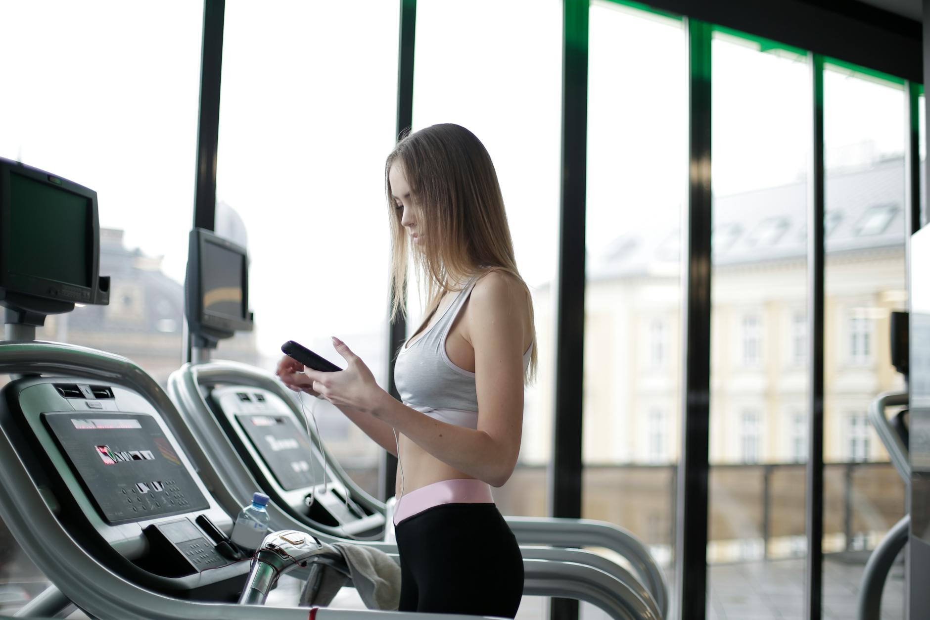 Cardio Equipment at Budget-Friendly Gyms 2026 Woman using a treadmill at the gym — cardio machines are the centerpiece of Planet Fitness locations