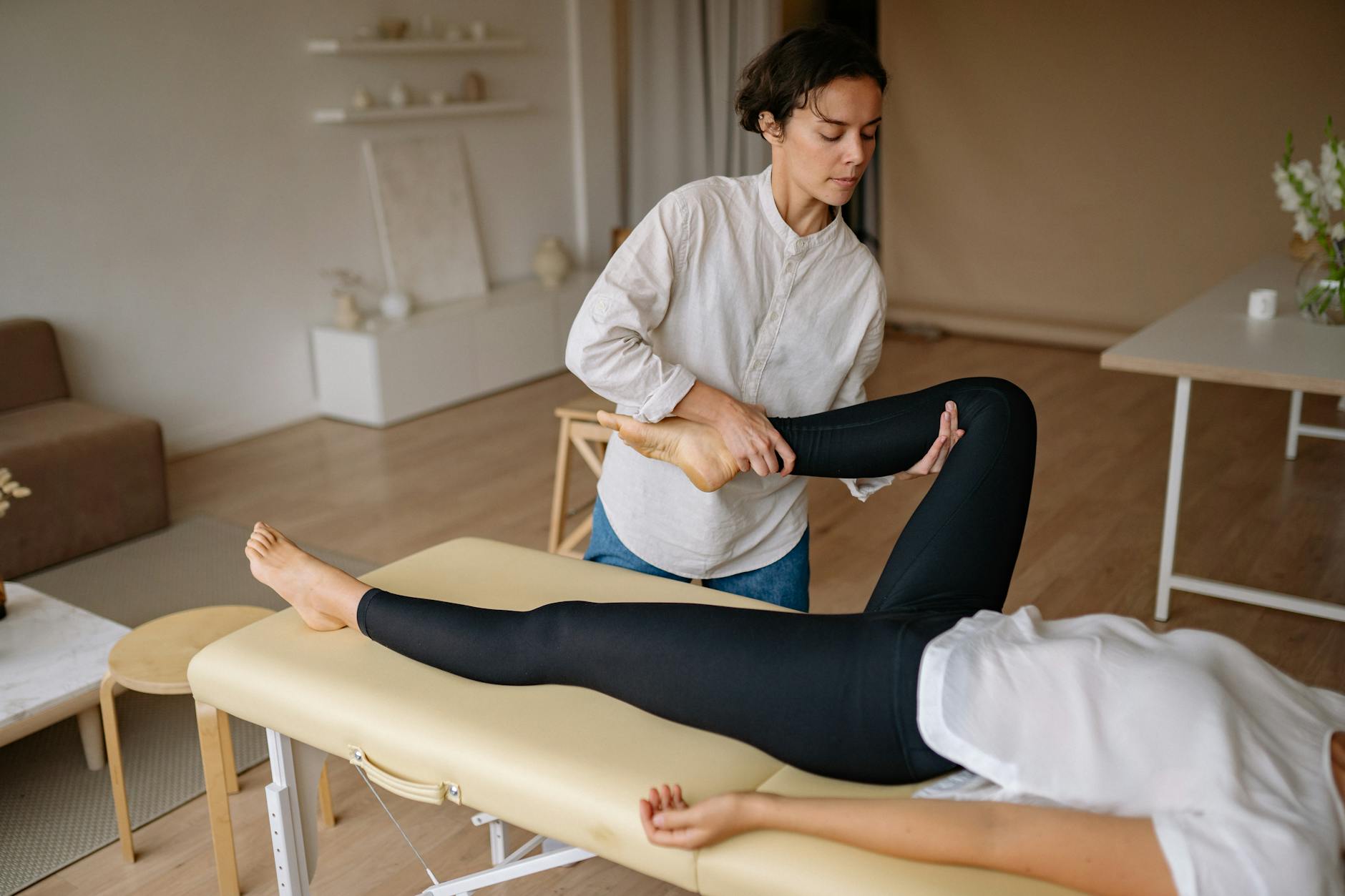 Leg Massage Therapy for Restless Leg Syndrome Relief Massage therapist performing a leg massage treatment to relieve muscle tension and RLS symptoms