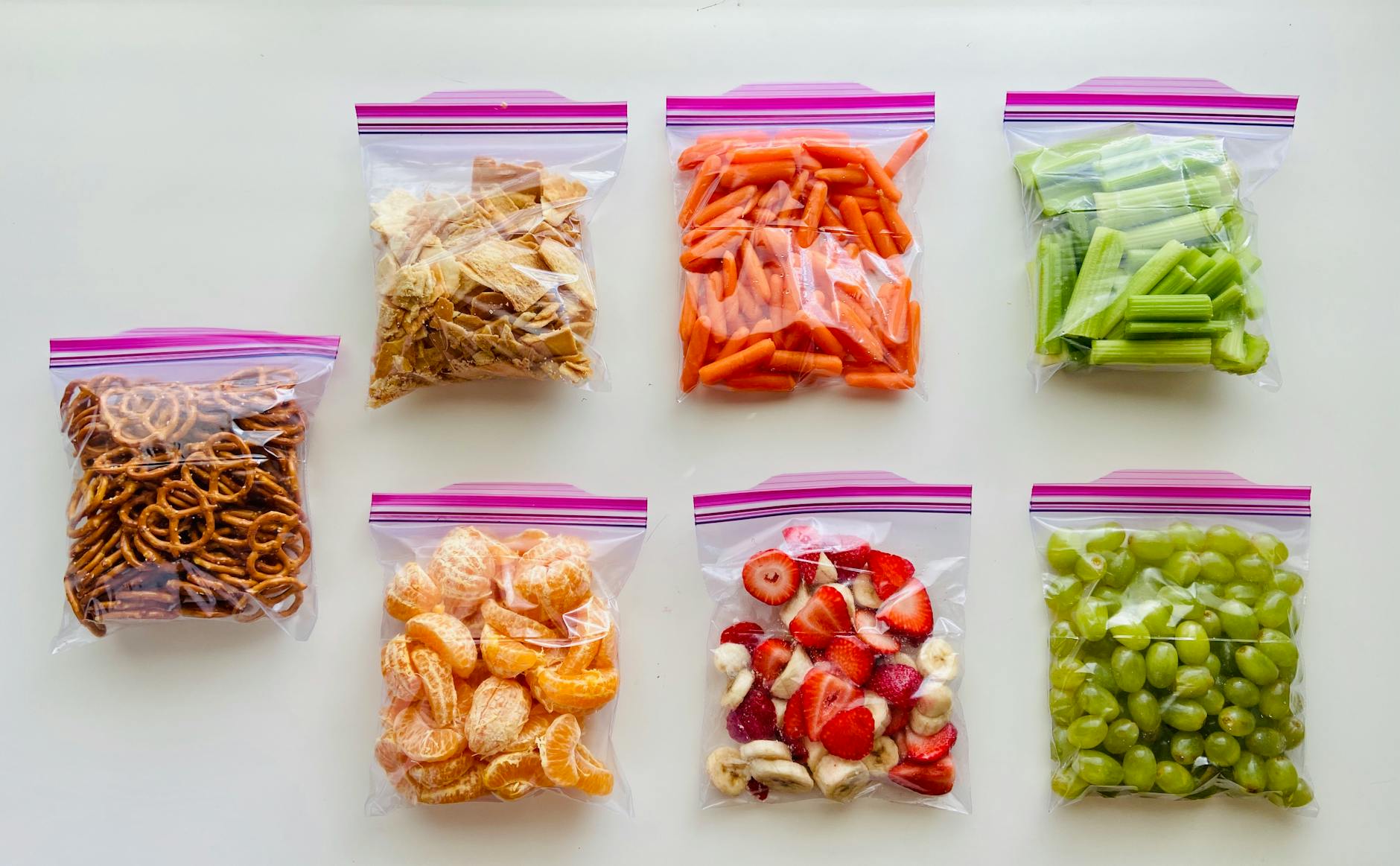 Organized Road Trip Snack Bags 2026 Fruits, vegetables, and snacks packed neatly in organized zip-lock bags for travel