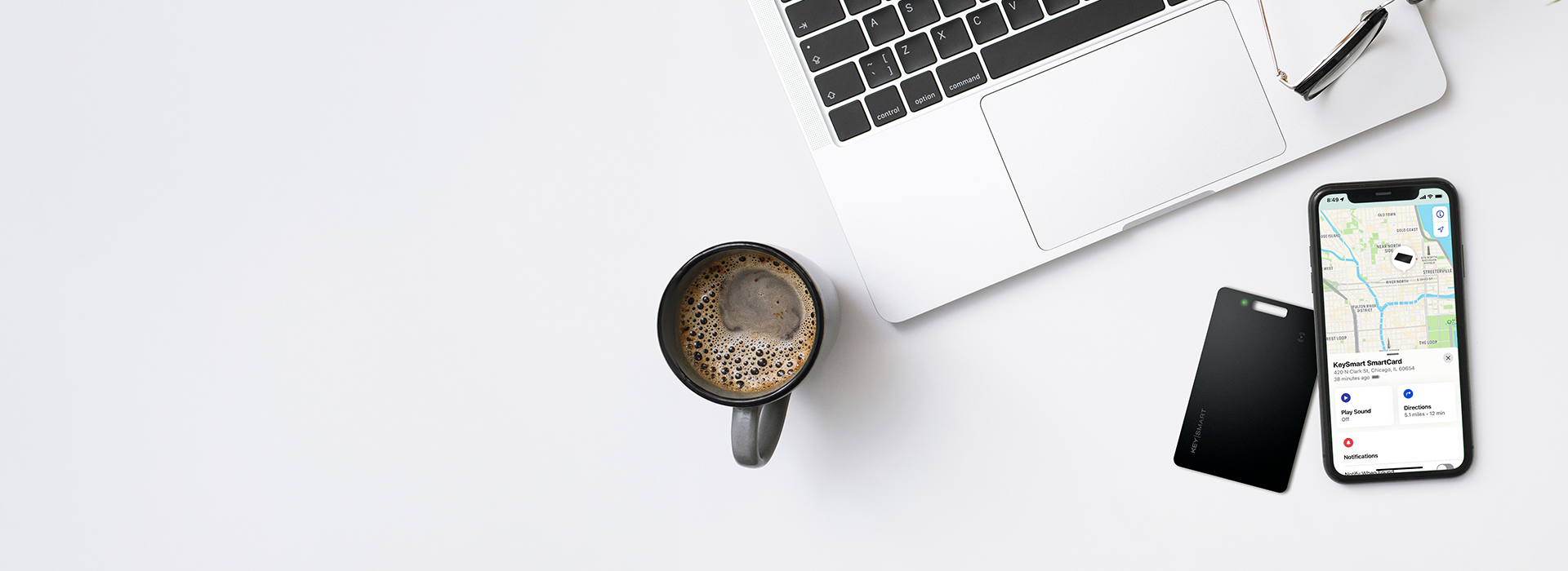 SmartCard by KeySmart with Apple Find My — 2026 Review Person holding the SmartCard by KeySmart alongside a smartphone showing Apple Find My app