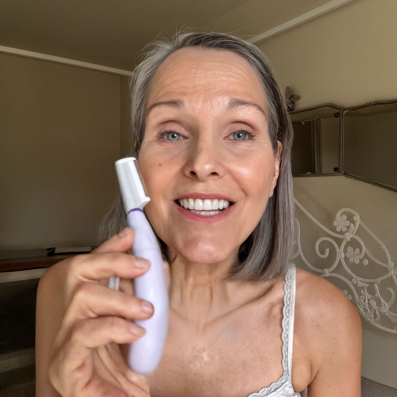 SonicSmooth Pro+ At-Home Dermaplaning Tool in Use Woman using SonicSmooth Pro+ sonic dermaplaning device on her cheek