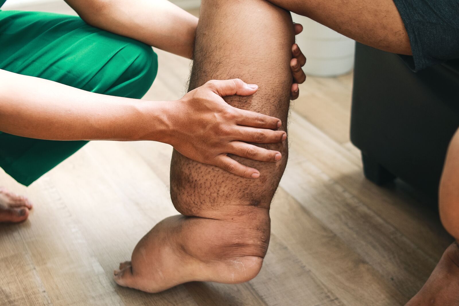 TheraFoot Pro In Use - Blue LED EMS Therapy 2026 Person using TheraFoot Pro EMS foot massager while standing on mat with blue LED activated