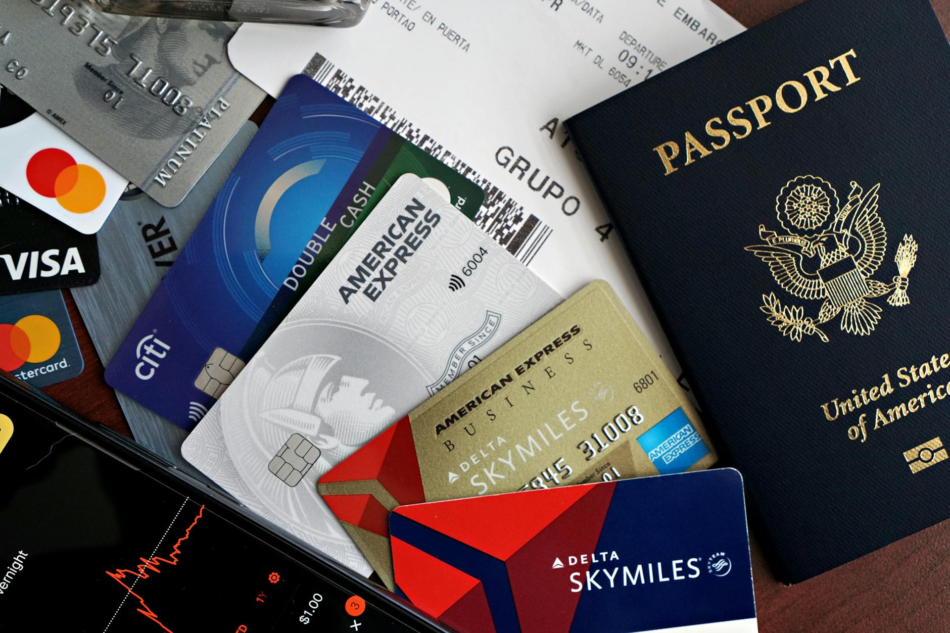 Travel Safety Essentials: Passport, Cards, and Boarding Pass Travel essentials laid out including passport, credit cards, and boarding pass