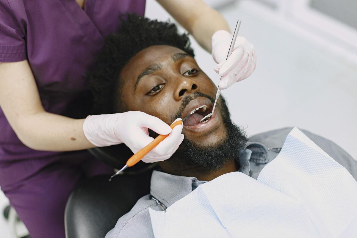Professional Dental Exam for Bleeding Gums Dentist examining a patient's teeth and gums during a routine dental checkup