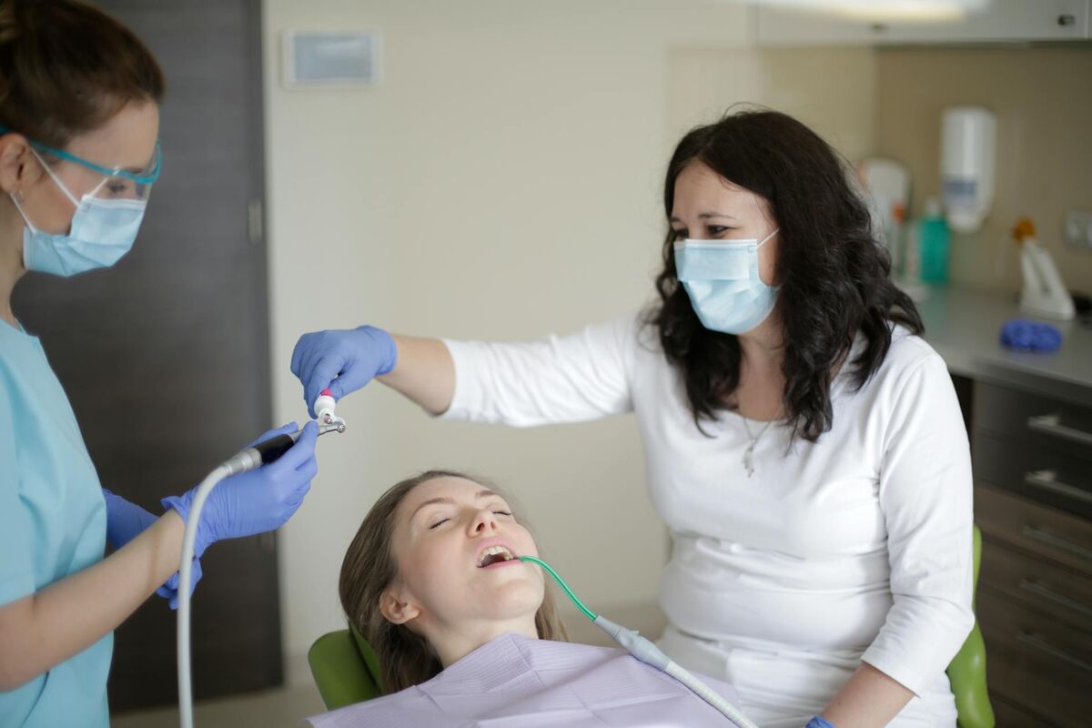 Clinical research on xylitol and cavity prevention spans decades of controlled trials Patient receiving dental treatment in a dentist's chair representing cavity prevention